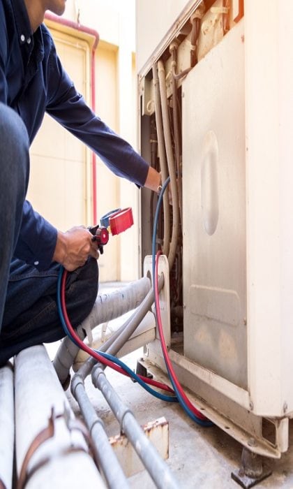 Technician is checking air conditioner ,measuring equipment for filling air conditioners.