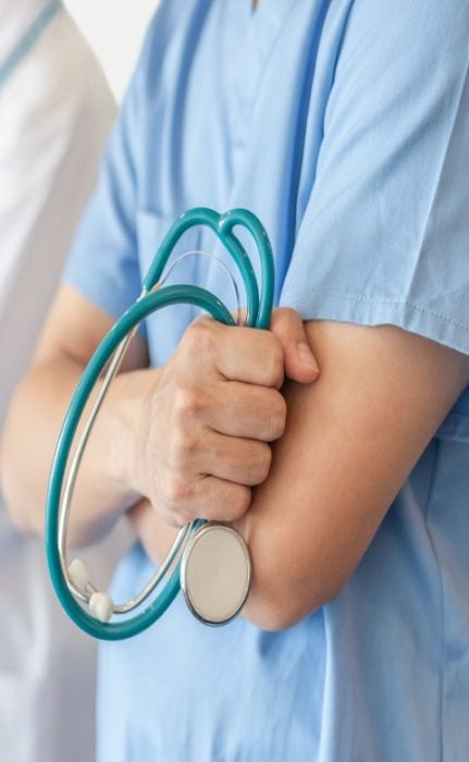 Surgeon and anesthetist doctor ER team with medical clinic room background for emergency nursing care professional teamwork and patient trust in hospital's hospitality concept